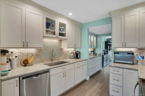 a kitchen with sink and cabinets