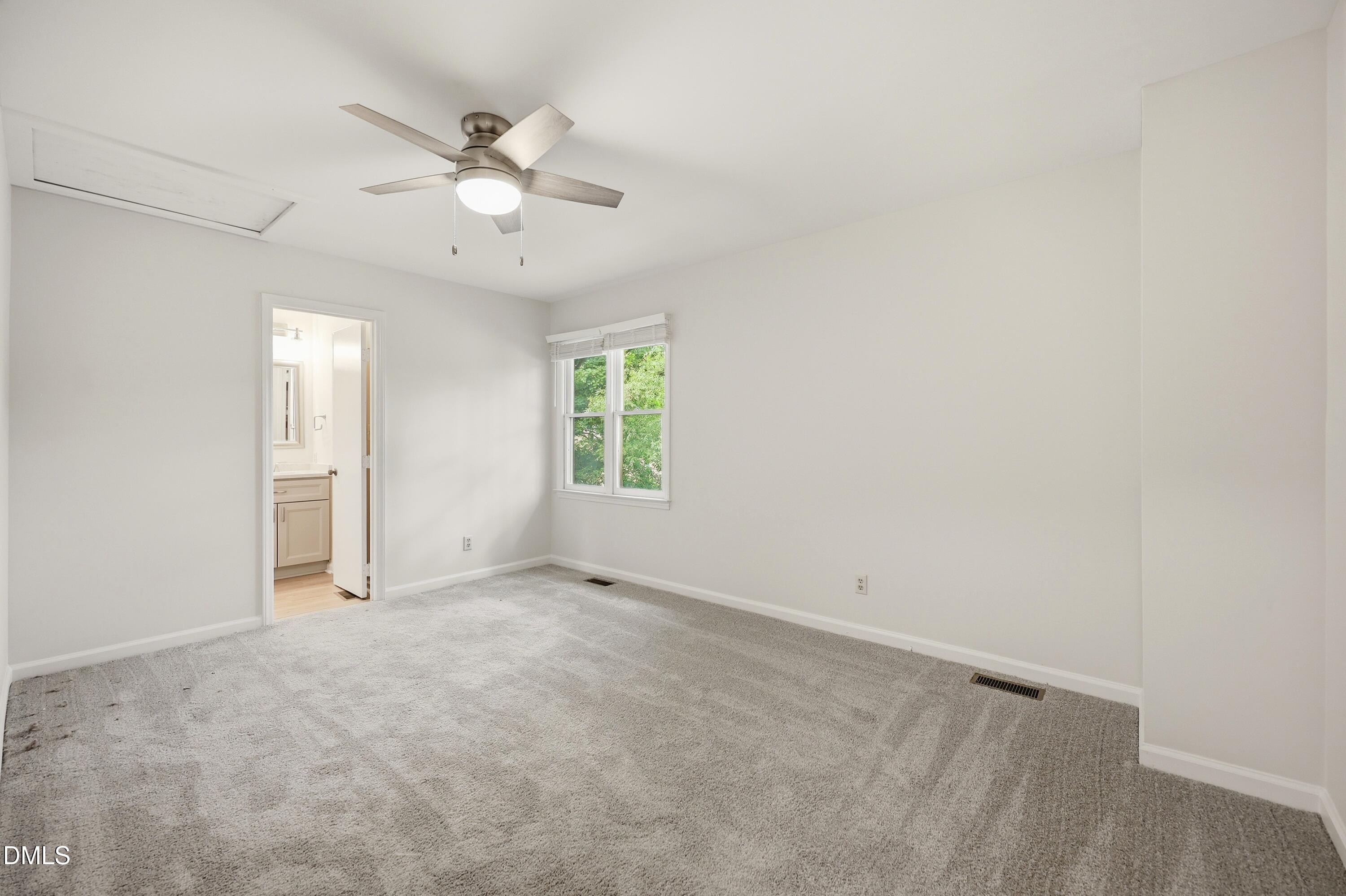 669 Bashford Road Raleigh, NC 27606 - Photo 8 of 19 an empty room with a window and a ceiling fan