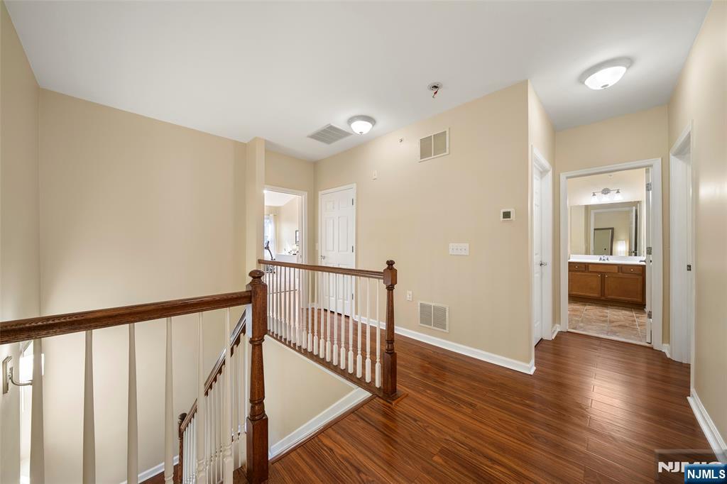 3 Holly Lane Garfield, NJ 07026 - Photo 11 of 34 a view of a hallway with wooden floor and a bathroom