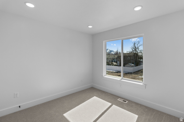 248 West 2920th Street South Logan, UT 84321 - Photo 42 of 47 Recessed lighting, large window, mountain backdrop, carpeting, neutral wall finish