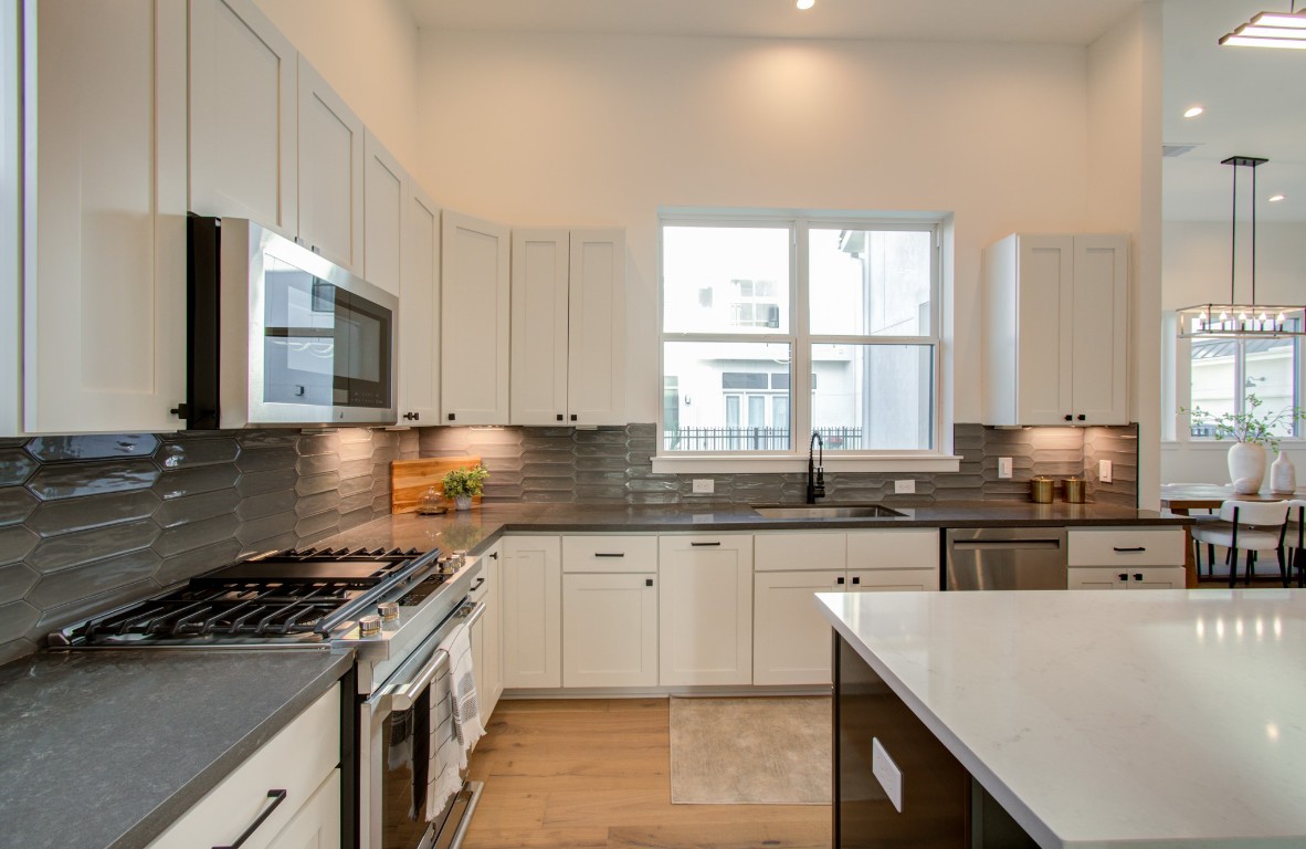 1645 Bingle Road Houston, TX 77055 - Photo 23 of 50 a kitchen with stainless steel appliances a sink stove and cabinets