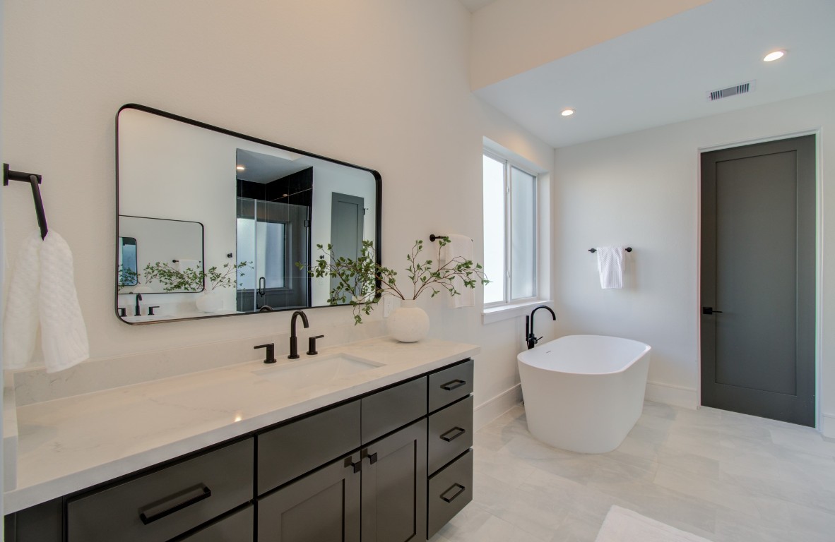 1645 Bingle Road Houston, TX 77055 - Photo 35 of 50 a spacious bathroom with a double vanity sink a mirror and a bathtub