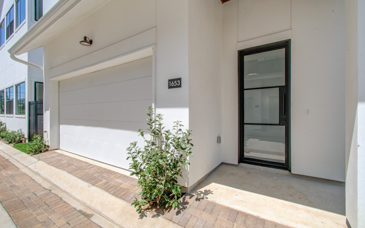 1645 Bingle Road Houston, TX 77055 - Photo 7 of 50 a potted plant in front of a door