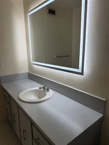 a view of a house with a big yard and palm trees