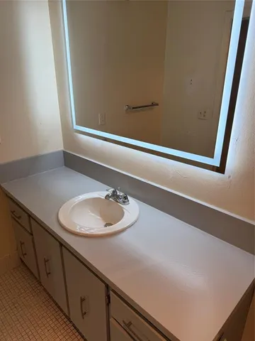 a living room with furniture a wooden floor and a potted plant