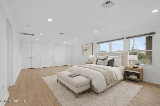 a large bedroom with a bed and large window