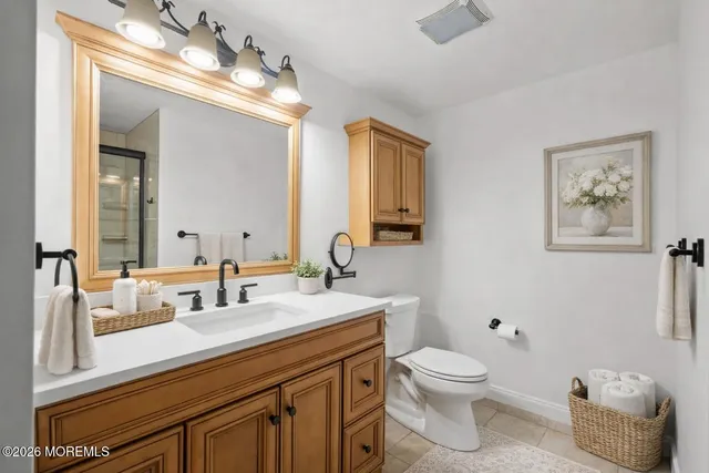 a bathroom with a toilet a sink and mirror