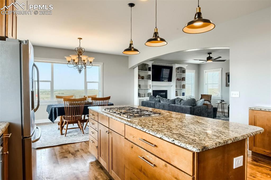 34698 Southern Cross Loop Kiowa, CO 80117 - Photo 13 of 50 a kitchen with a stove a chandelier and a refrigerator