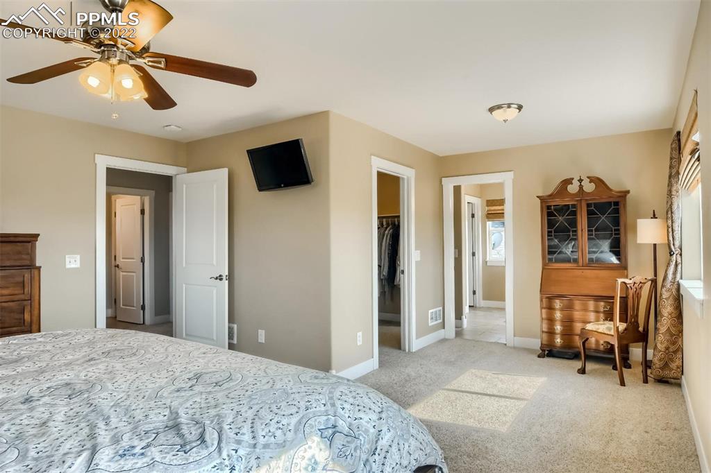 34698 Southern Cross Loop Kiowa, CO 80117 - Photo 17 of 50 a bedroom with a bed a flat screen tv and dresser