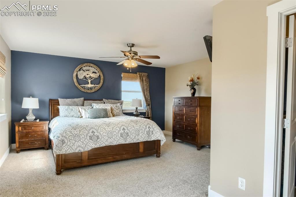 34698 Southern Cross Loop Kiowa, CO 80117 - Photo 18 of 50 a bedroom with a bed and a clock on the wall