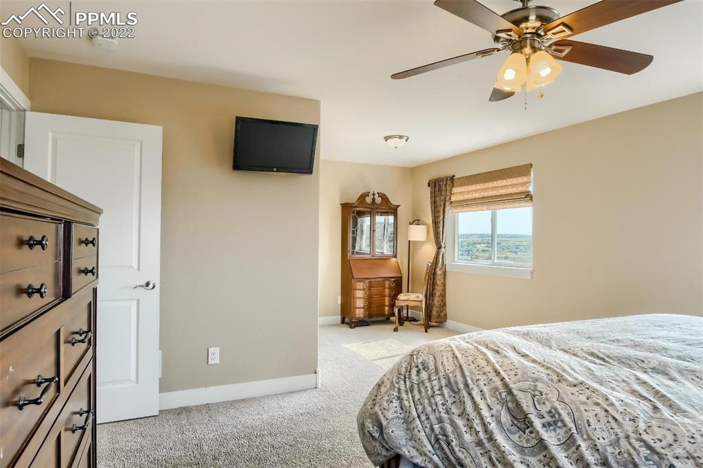 34698 Southern Cross Loop Kiowa, CO 80117 - Photo 19 of 50 a bedroom with a bed and a flat tv screen on dresser