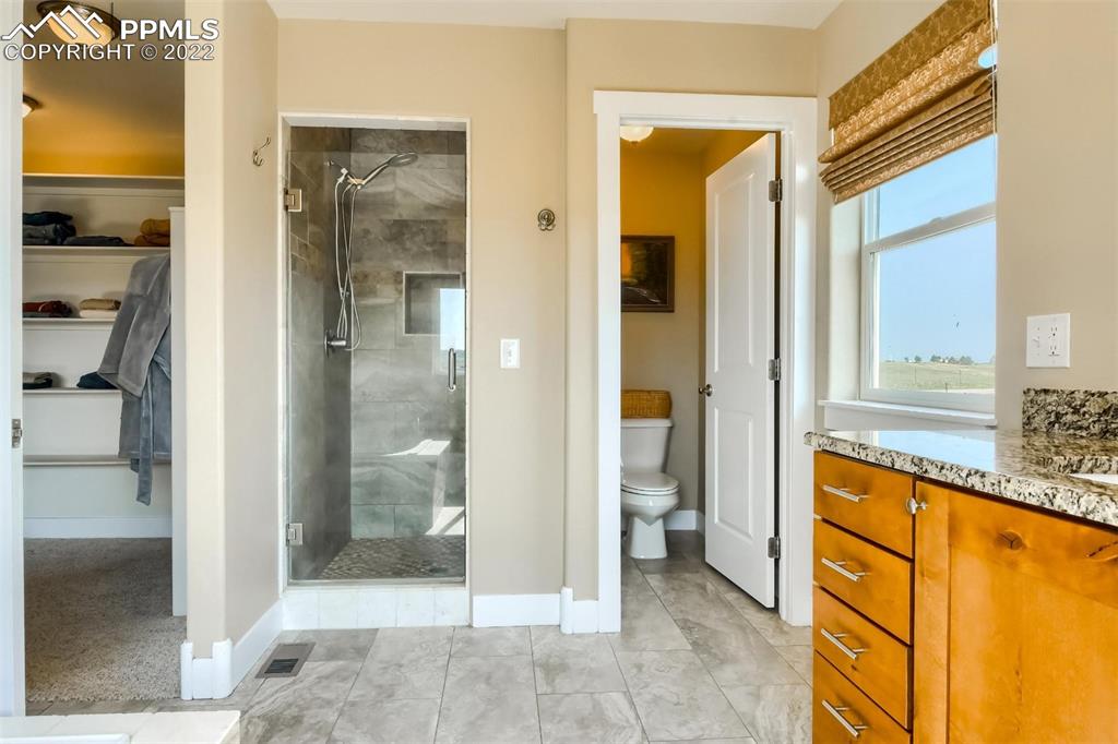 34698 Southern Cross Loop Kiowa, CO 80117 - Photo 22 of 50 a view of a bathroom with a tub and shower