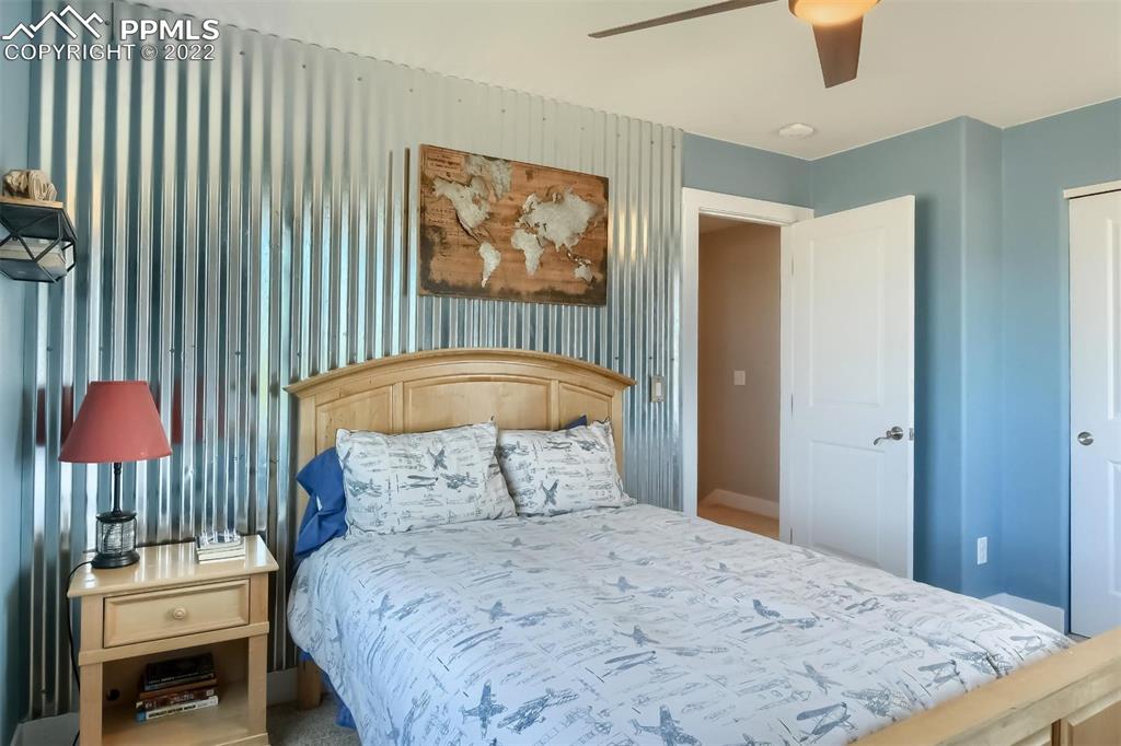 34698 Southern Cross Loop Kiowa, CO 80117 - Photo 24 of 50 a bedroom with a bed and a painting on the wall