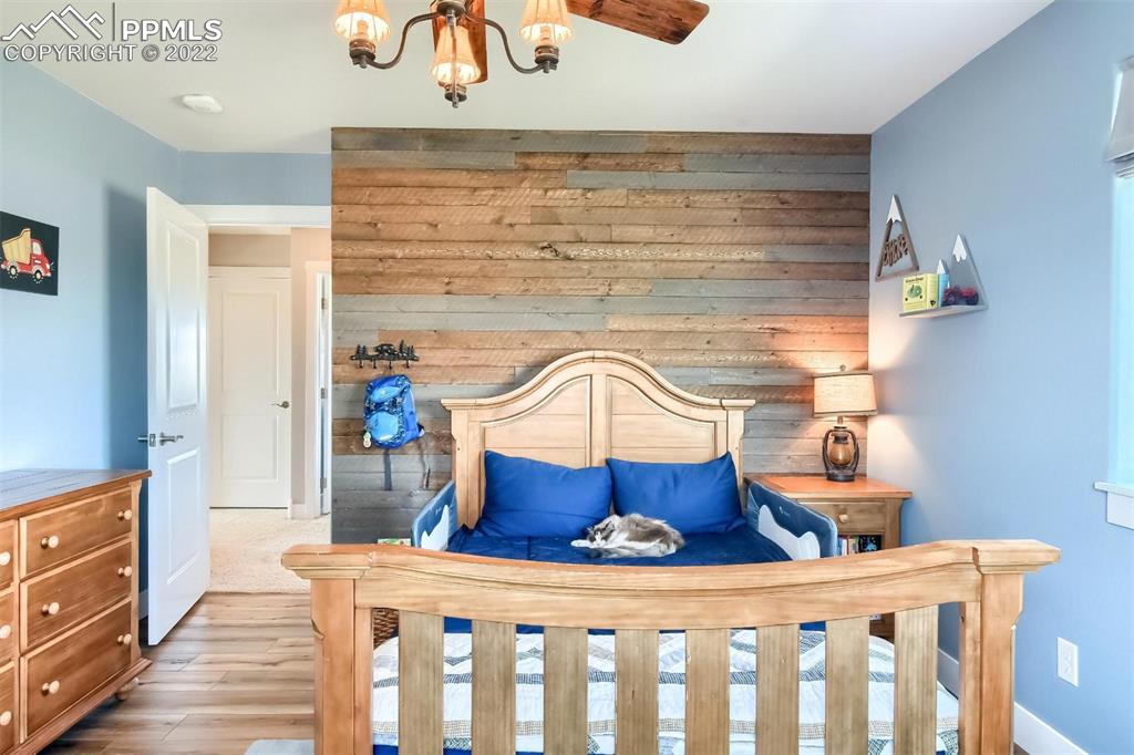 34698 Southern Cross Loop Kiowa, CO 80117 - Photo 25 of 50 a bedroom with a bed and wooden floor