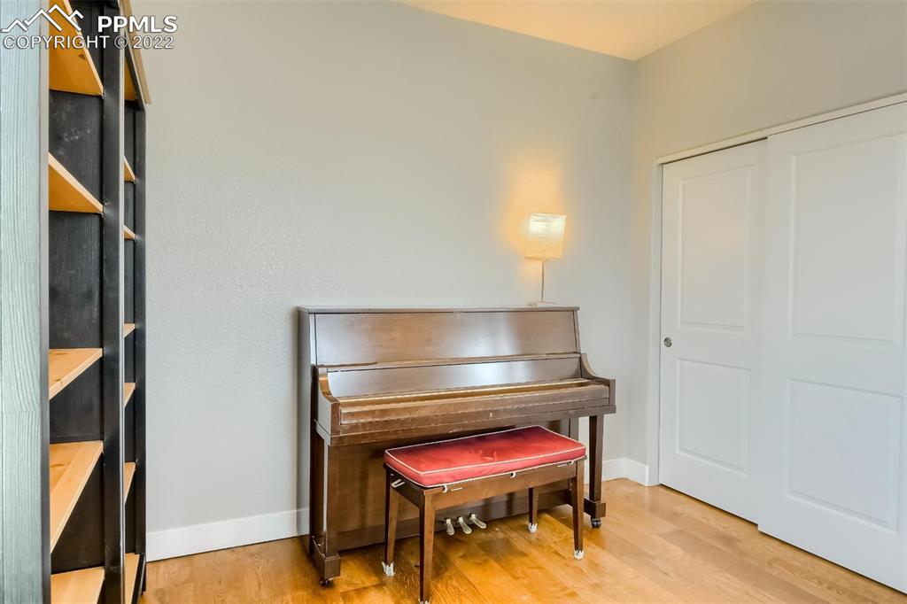 34698 Southern Cross Loop Kiowa, CO 80117 - Photo 30 of 50 a room with a piano and wooden floor