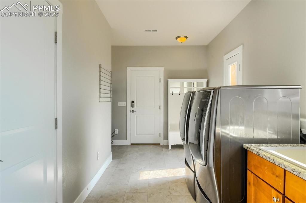 34698 Southern Cross Loop Kiowa, CO 80117 - Photo 32 of 50 a view of a refrigerator in kitchen and wooden floor