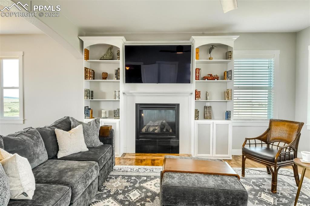 34698 Southern Cross Loop Kiowa, CO 80117 - Photo 5 of 50 a living room with furniture and a fireplace