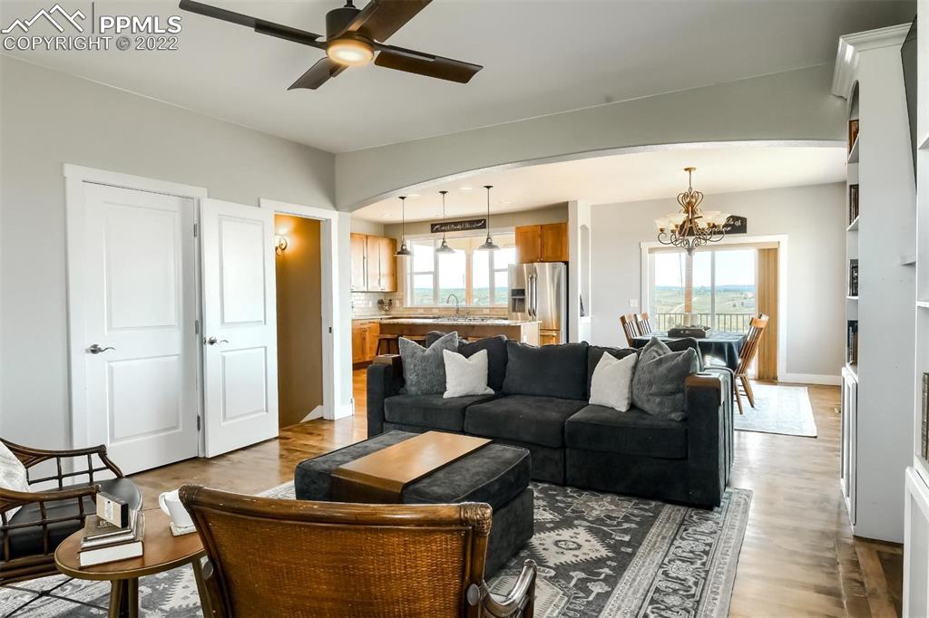34698 Southern Cross Loop Kiowa, CO 80117 - Photo 7 of 50 a living room with furniture and a chandelier