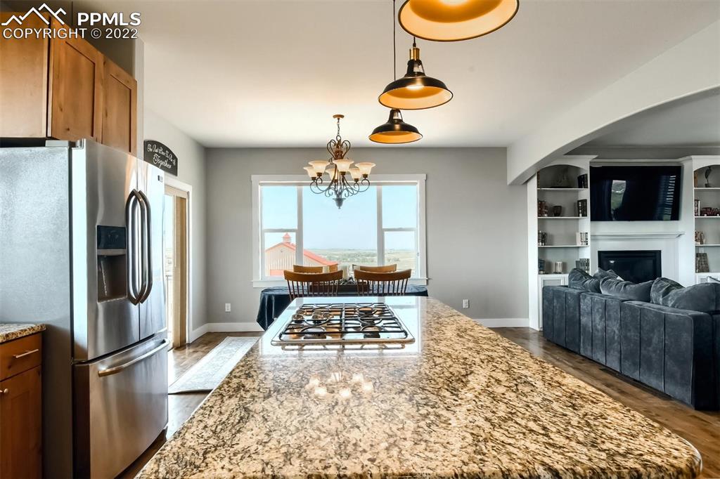 34698 Southern Cross Loop Kiowa, CO 80117 - Photo 10 of 50 a living room with stainless steel appliances furniture a rug and a fireplace