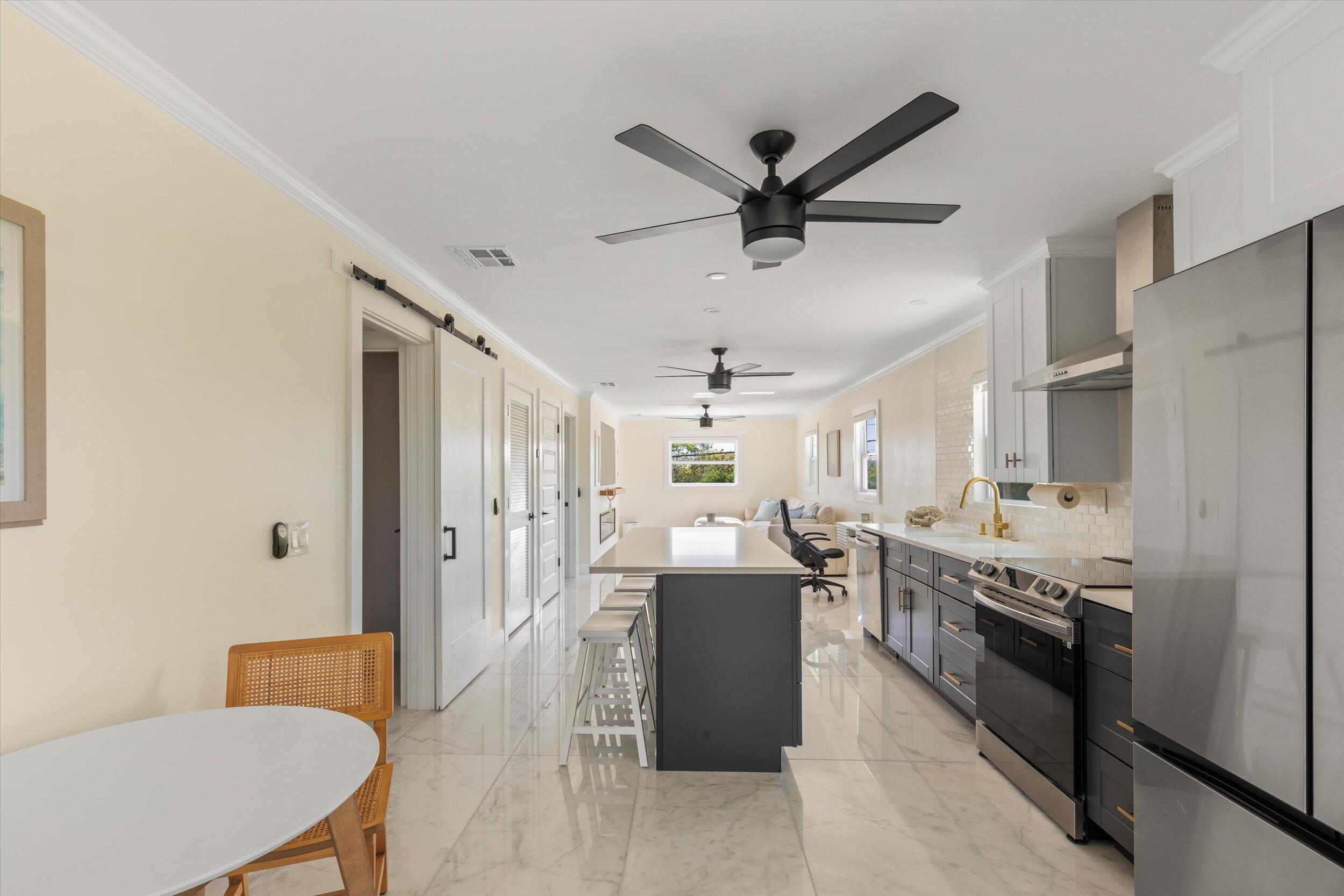 28009 Gulf Boulevard Big Pine Key, FL 33043 - Photo 5 of 42 a living room with stainless steel appliances granite countertop furniture a couch and a view of kitchen