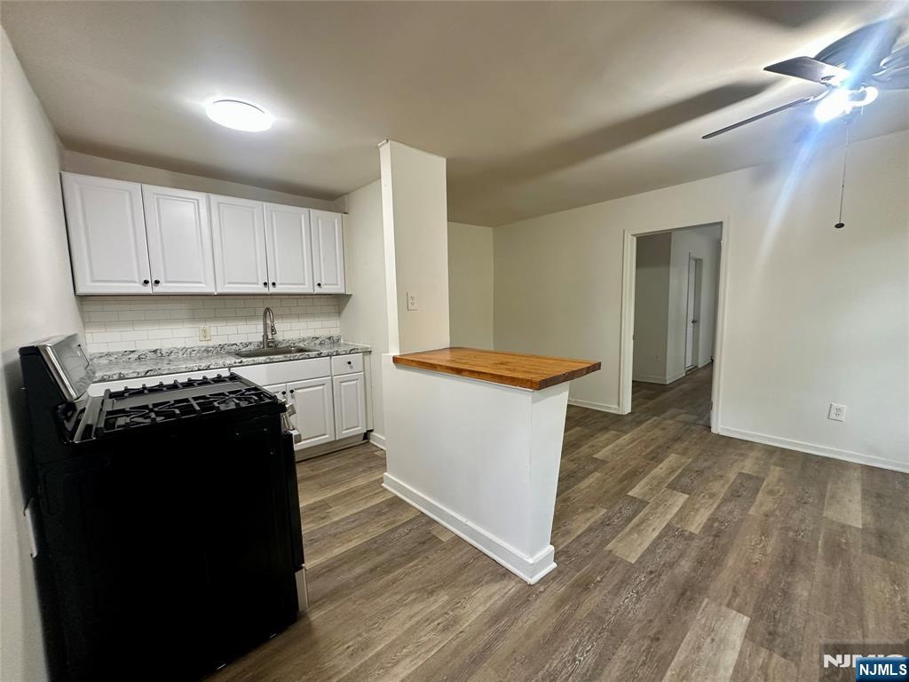 a kitchen with a sink and a stove top oven
