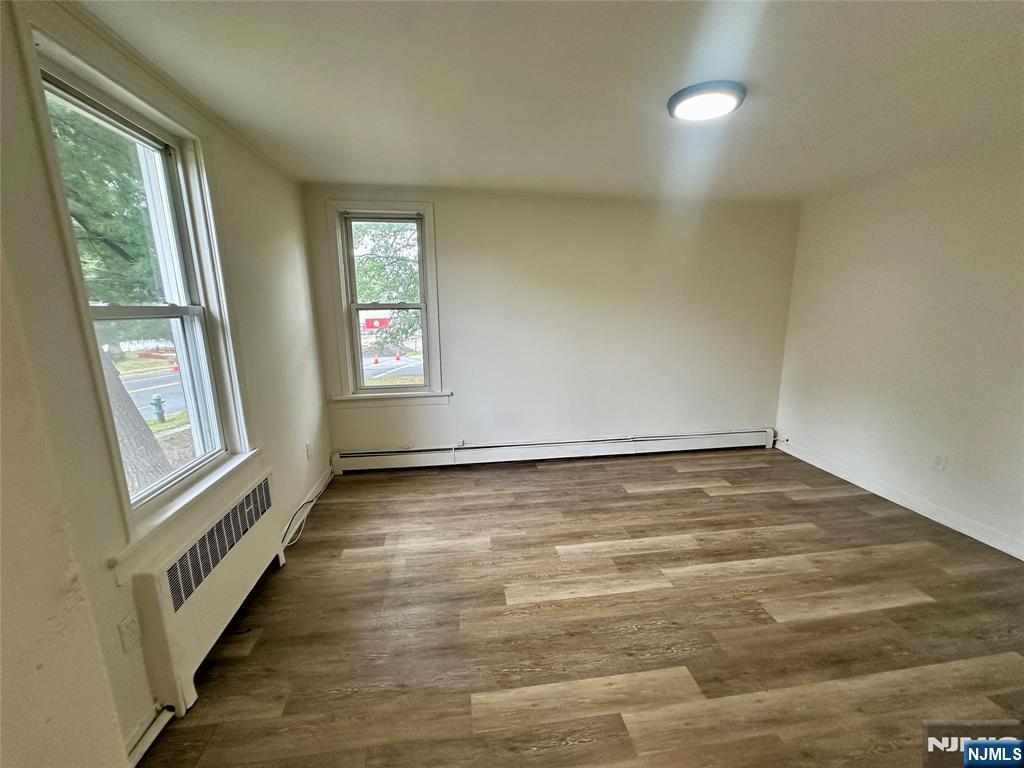390 Orange Road Montclair, NJ 07042 - Photo 11 of 16 an empty room with wooden floor and windows