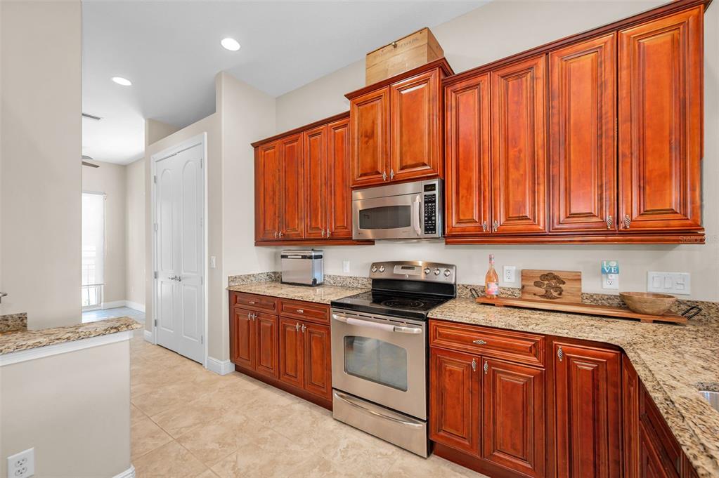 47 West Morgan Street Tarpon Springs, FL 34689 - Photo 12 of 64 a kitchen with stainless steel appliances granite countertop a stove a sink dishwasher and a microwave oven with cabinets