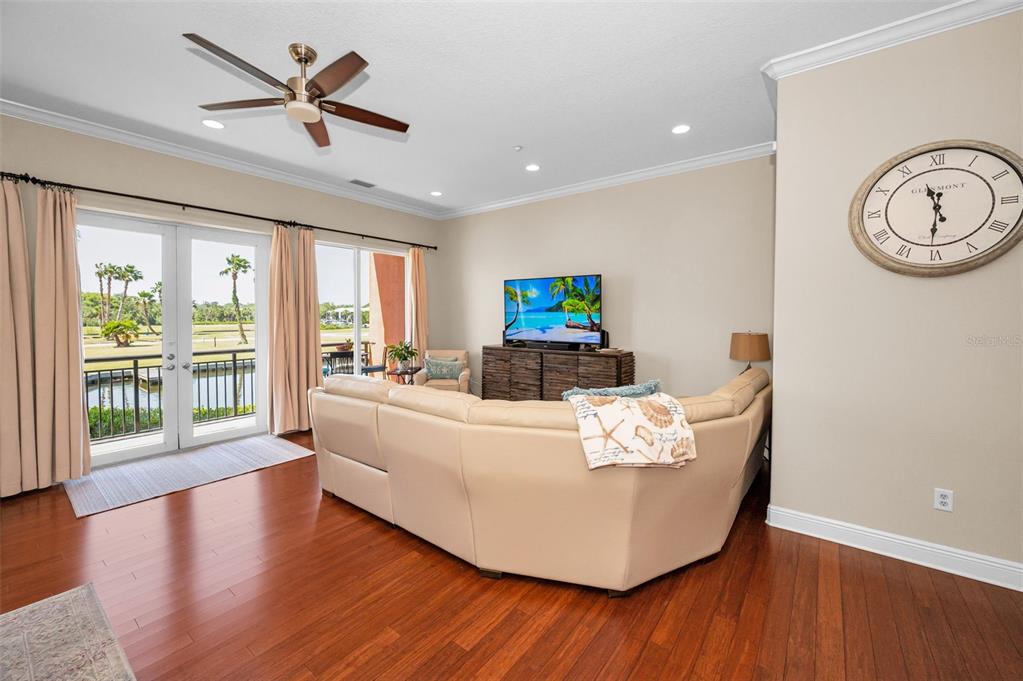 47 West Morgan Street Tarpon Springs, FL 34689 - Photo 16 of 64 a living room with couches and a large window with wooden floor