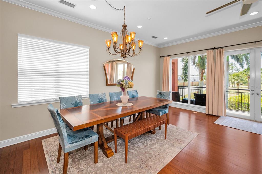 47 West Morgan Street Tarpon Springs, FL 34689 - Photo 21 of 64 a view of a dining room with furniture wooden floor and chandelier