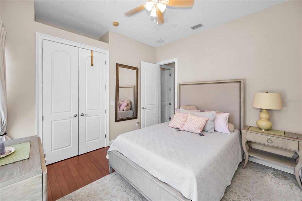 47 West Morgan Street Tarpon Springs, FL 34689 - Photo 31 of 64 a bedroom with a bed and a chandelier