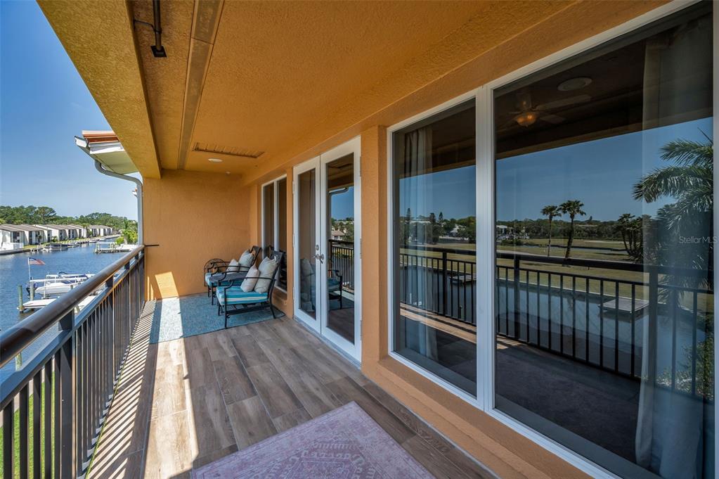 47 West Morgan Street Tarpon Springs, FL 34689 - Photo 37 of 64 a view of a balcony with wooden floor