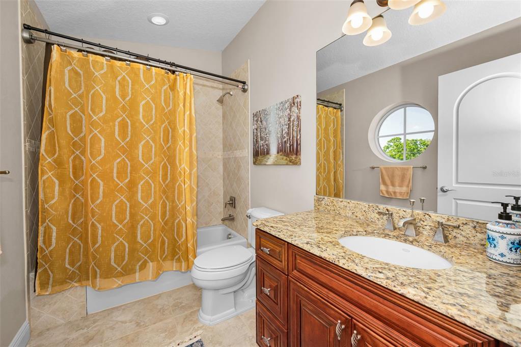 47 West Morgan Street Tarpon Springs, FL 34689 - Photo 51 of 64 a bathroom with a granite countertop sink toilet and shower