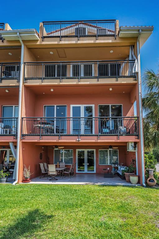47 West Morgan Street Tarpon Springs, FL 34689 - Photo 60 of 64 a view of a big building with a big yard and potted plants