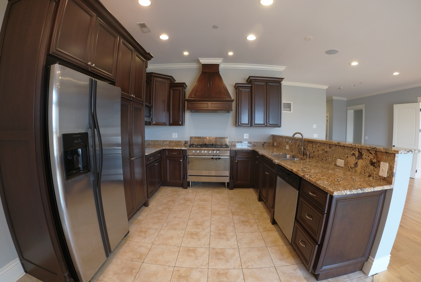 10765 Clock Tower Drive, Unit 602 Countryside, IL 60525 - Photo 6 of 21 a kitchen with stainless steel appliances granite countertop a stove a sink and a refrigerator