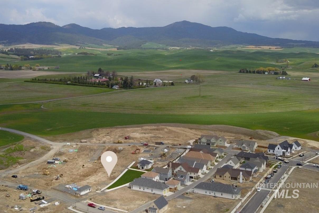 1463 Cottage Lane Moscow, ID 83843 - Photo 5 of 23 Expansive parcel within a developing residential area, featuring a distant mountainous backdrop and extensive green fields