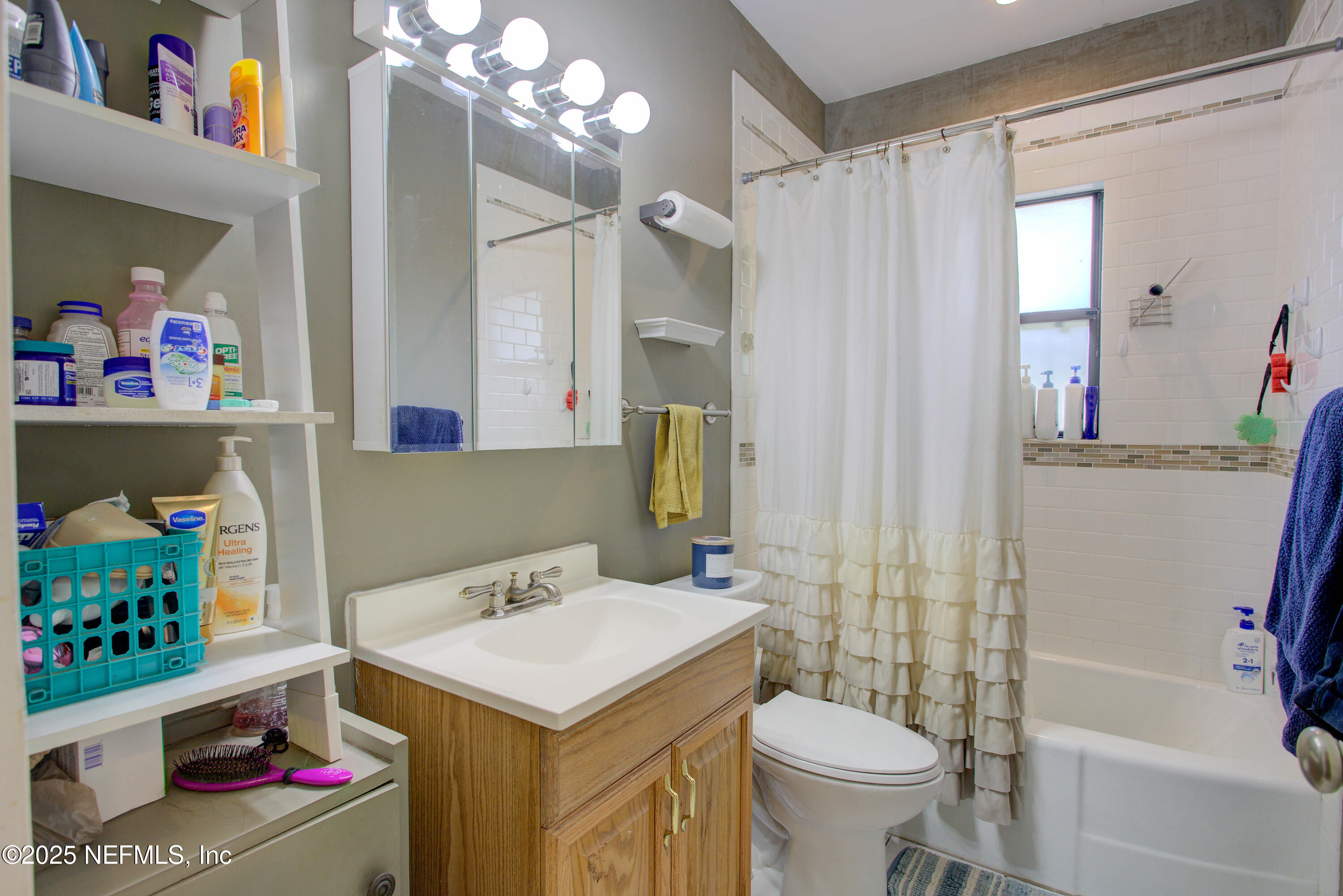 7861 State Road 21 Keystone Heights, FL 32656 - Photo 21 of 51 a bathroom with a sink vanity mirror and toilet