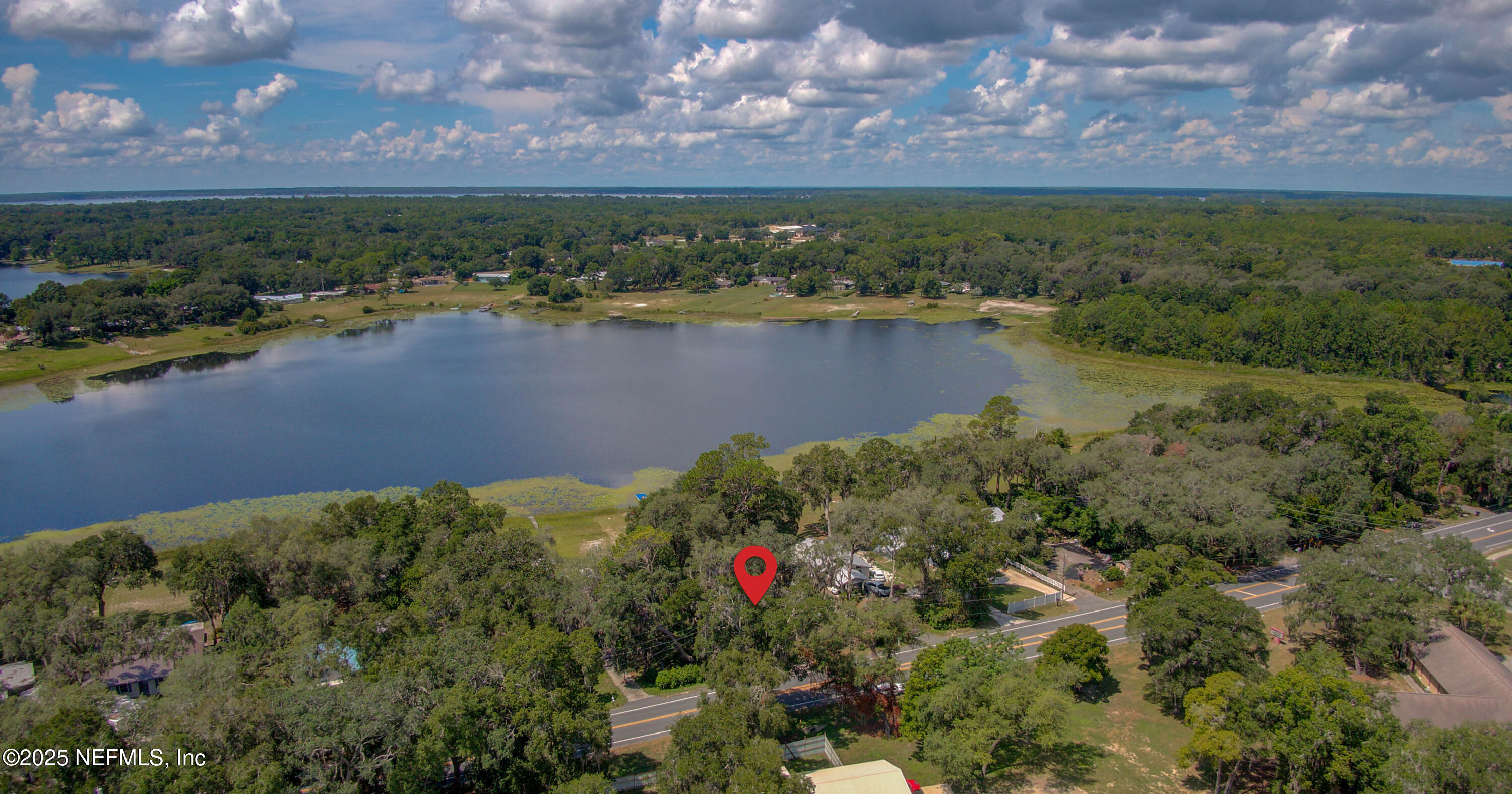 7861 State Road 21 Keystone Heights, FL 32656 - Photo 46 of 51 a view of a lake with a yard and mountain in the back