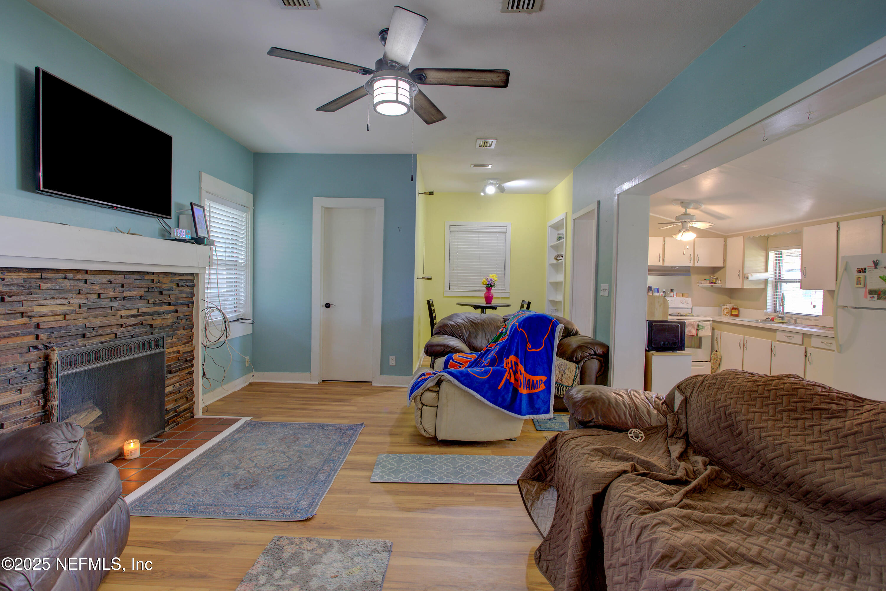 7861 State Road 21 Keystone Heights, FL 32656 - Photo 9 of 51 a living room with furniture a flat screen tv and a fireplace