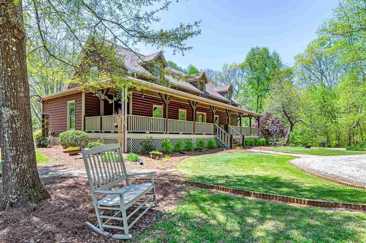 a front view of a house with garden and porch