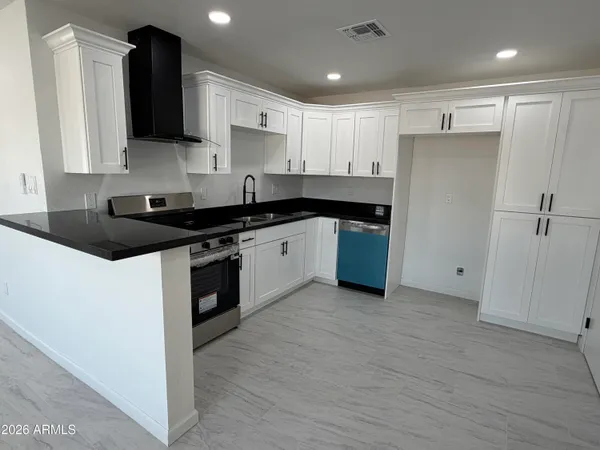 a kitchen with a sink stove and refrigerator