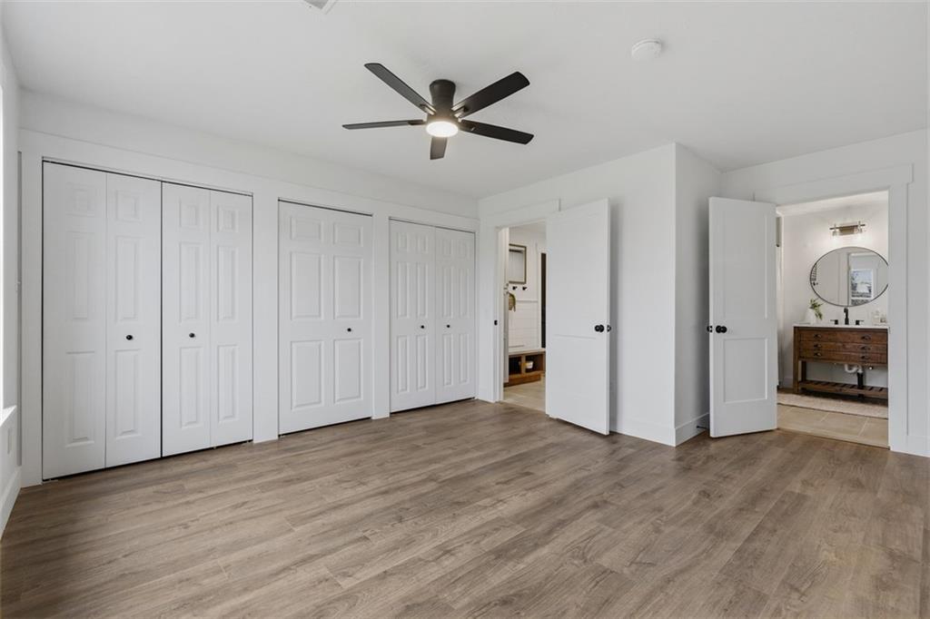 1006 Edgewood Road New Kensington, PA 15068 - Photo 26 of 47 a view of a livingroom with a wooden floor and a ceiling fan