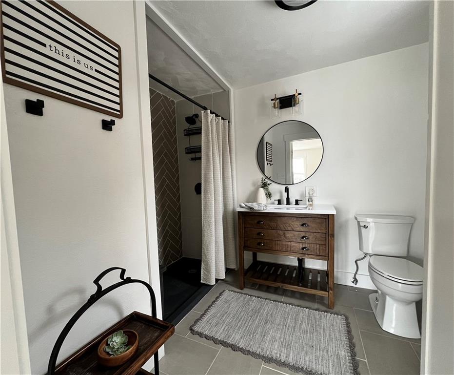 1006 Edgewood Road New Kensington, PA 15068 - Photo 29 of 47 a bathroom with a sink a toilet and a mirror