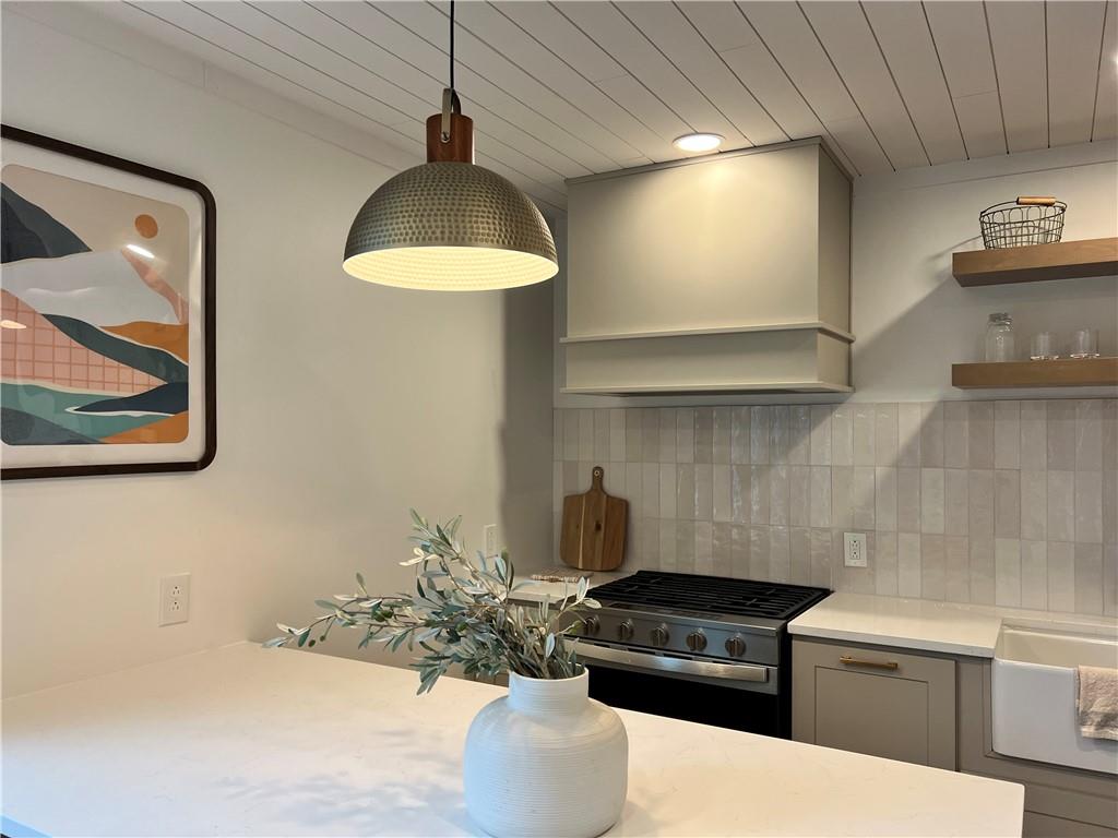 1006 Edgewood Road New Kensington, PA 15068 - Photo 9 of 47 a kitchen with kitchen island granite countertop a stove and a sink