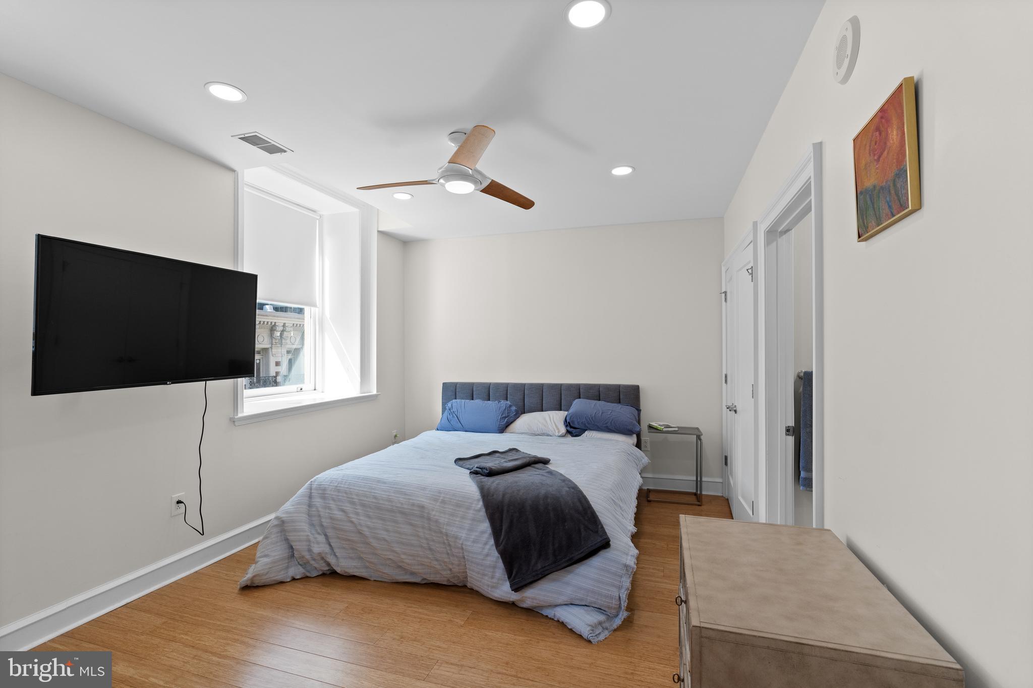 1811 Chestnut Street, Unit 501 Philadelphia, PA 19103 - Photo 12 of 26 a bedroom with a large bed and a flat screen tv