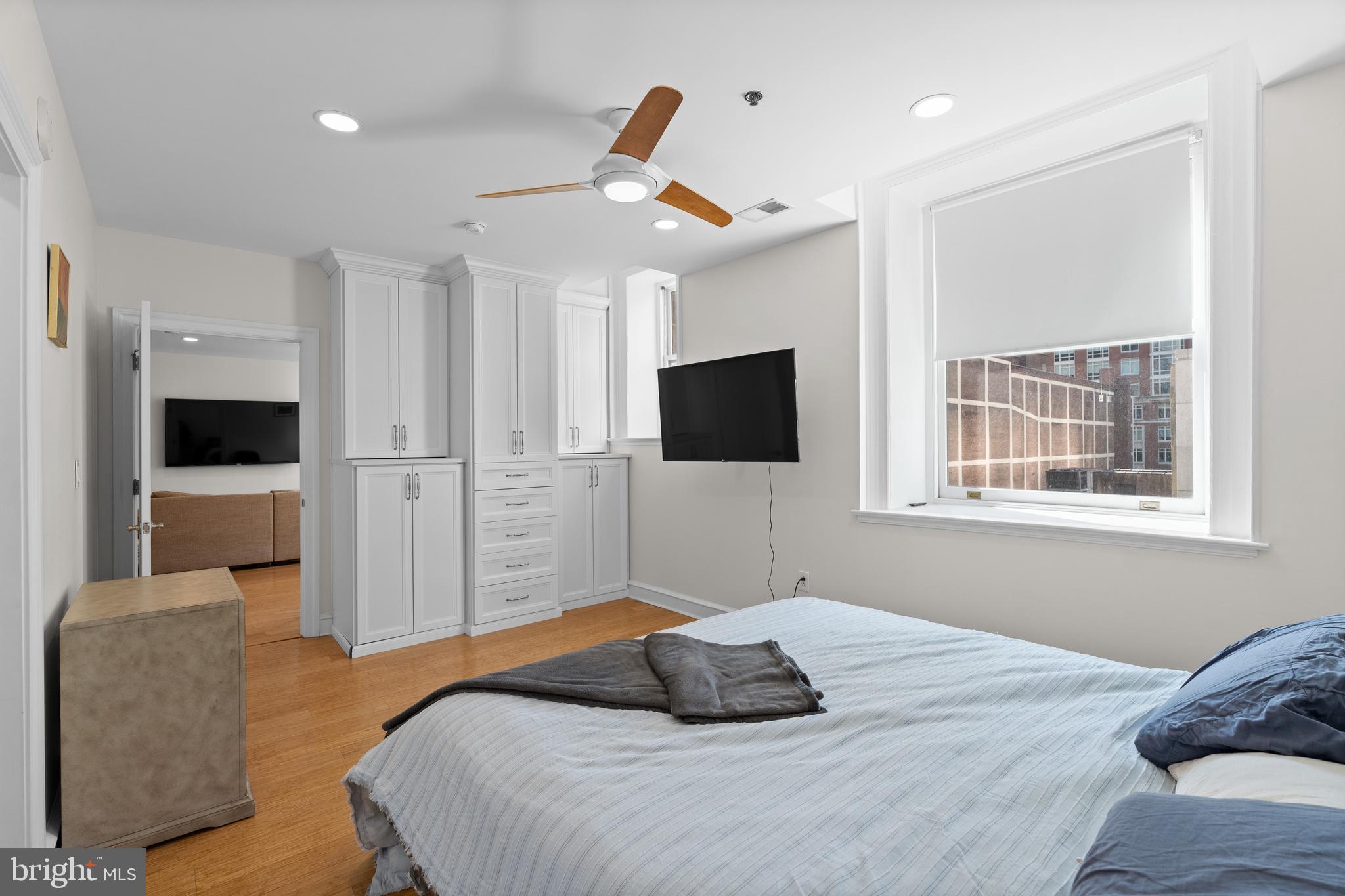 1811 Chestnut Street, Unit 501 Philadelphia, PA 19103 - Photo 13 of 26 a bedroom with a bed tv and chair