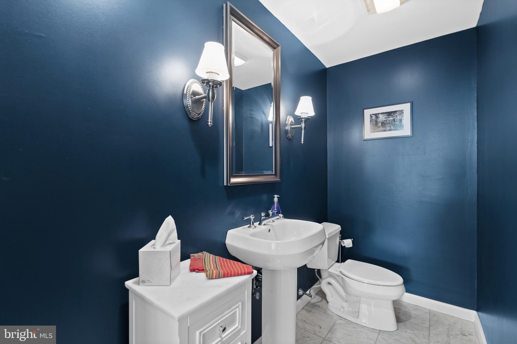 1811 Chestnut Street, Unit 501 Philadelphia, PA 19103 - Photo 18 of 26 a bathroom with a toilet sink and mirror