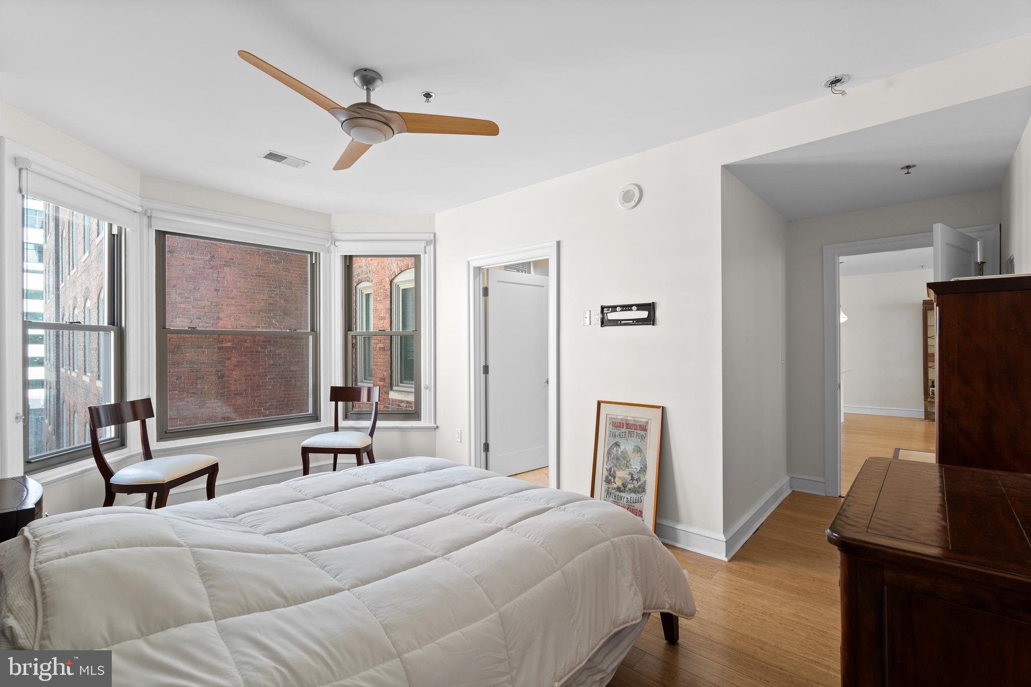 1811 Chestnut Street, Unit 501 Philadelphia, PA 19103 - Photo 20 of 26 a bedroom with a bed and a flat tv screen on dresser