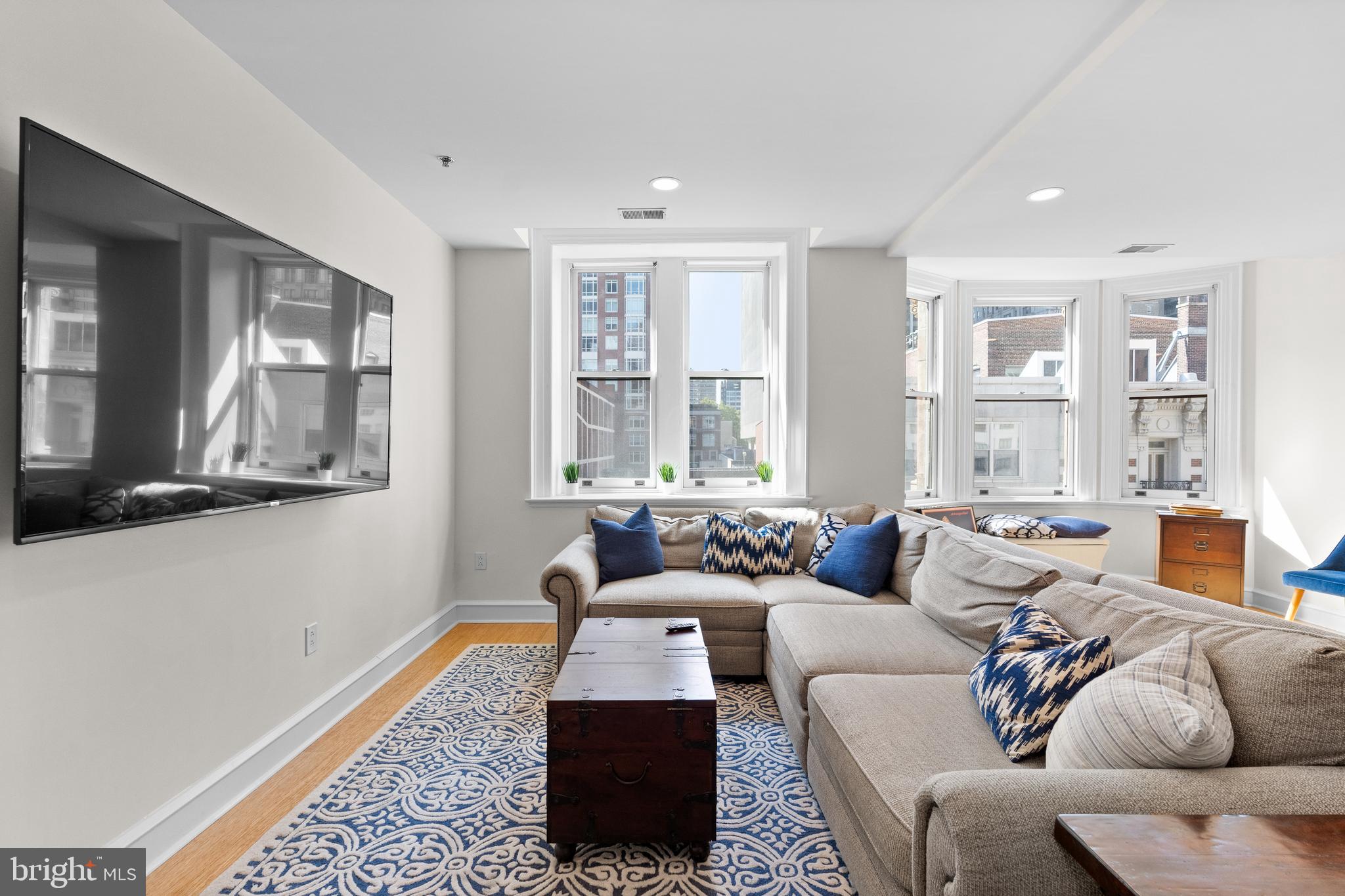 1811 Chestnut Street, Unit 501 Philadelphia, PA 19103 - Photo 5 of 26 a living room with furniture and a large window