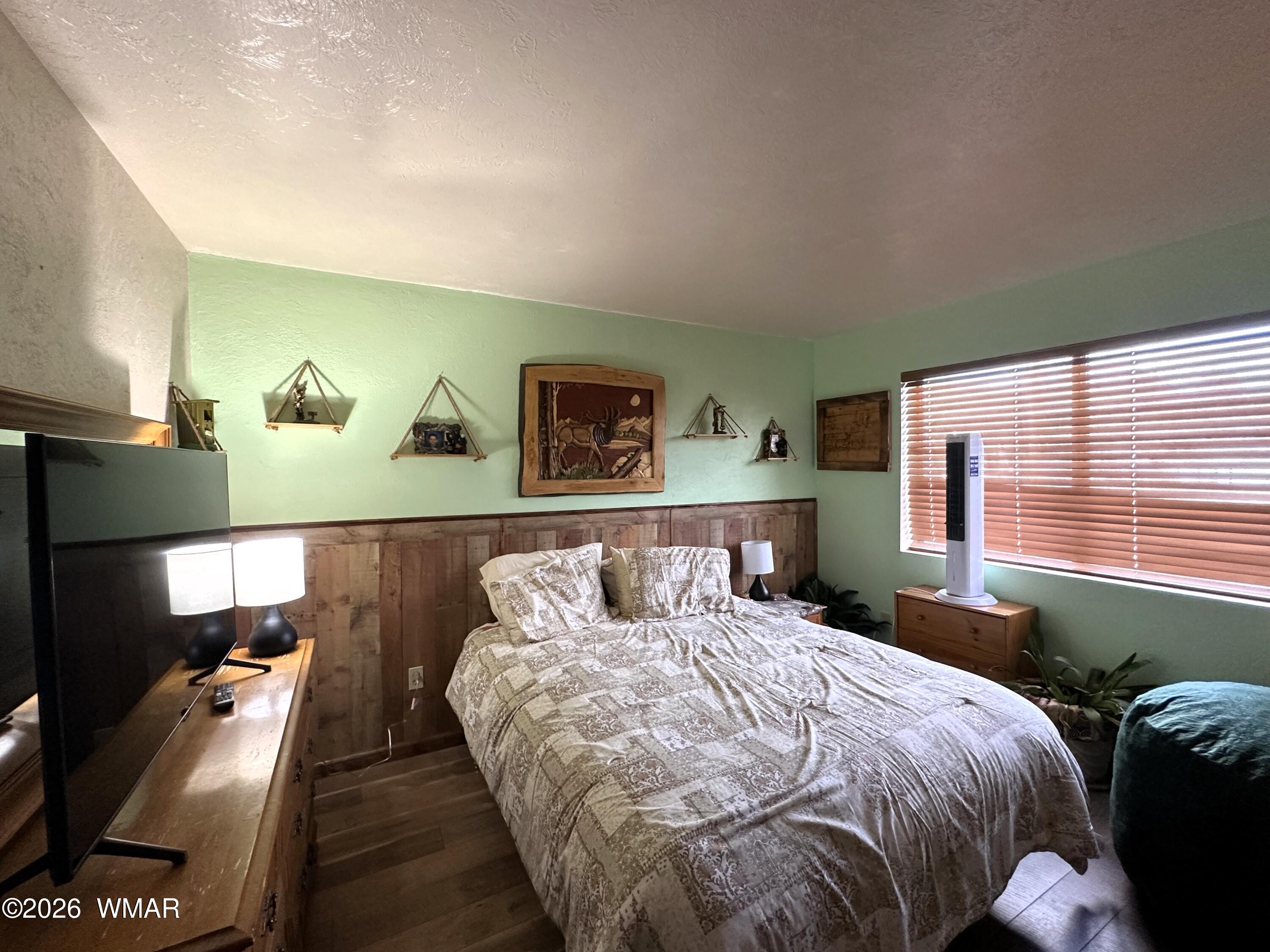 19 County Road Alpine, AZ 85920 - Photo 12 of 27 a bed sitting in a bedroom next to a window