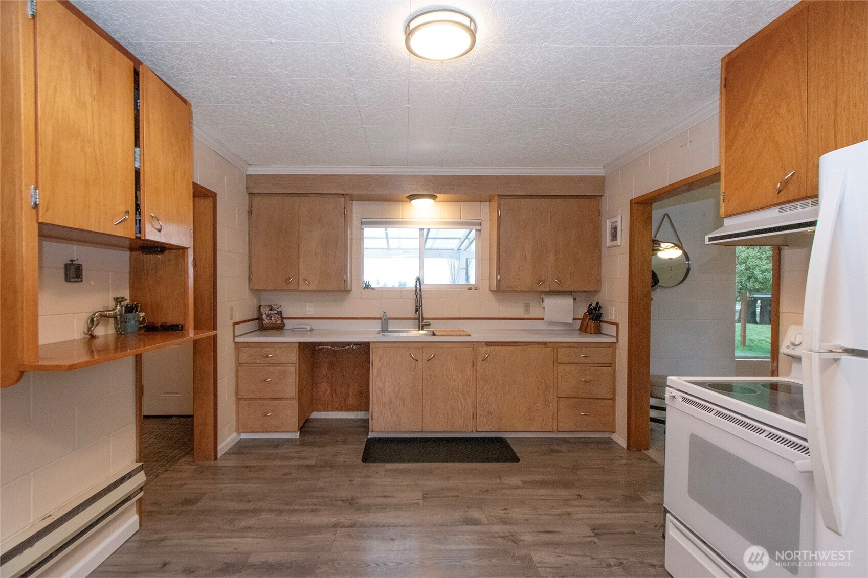 163 Cliff Robinson Lane Sequim, WA 98382 - Photo 13 of 40 a kitchen with a sink cabinets and window